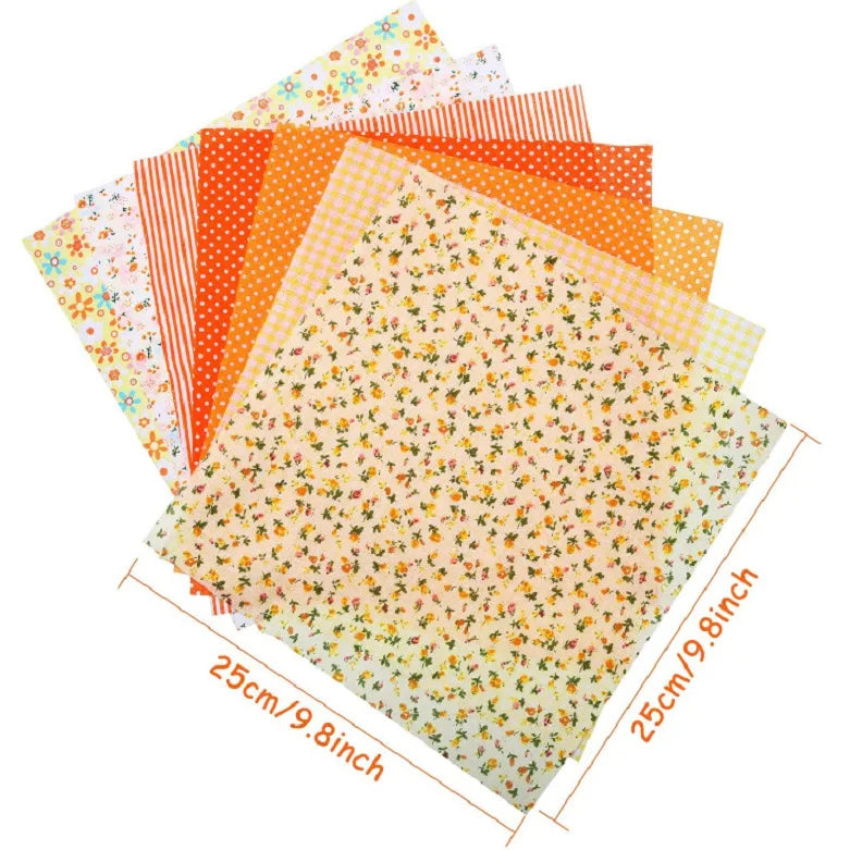 A bundle of cotton fabric squares featuring various floral dot patterns in orange, yellow, and pink hues.