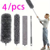 Four gray electrostatic dusters, including a long duster and three cylindrical cleaning tools, are shown being held by a woma