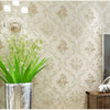 Close-up of a wall decorated with 3D self-adhesive floral wallpaper featuring silver and gold accents.