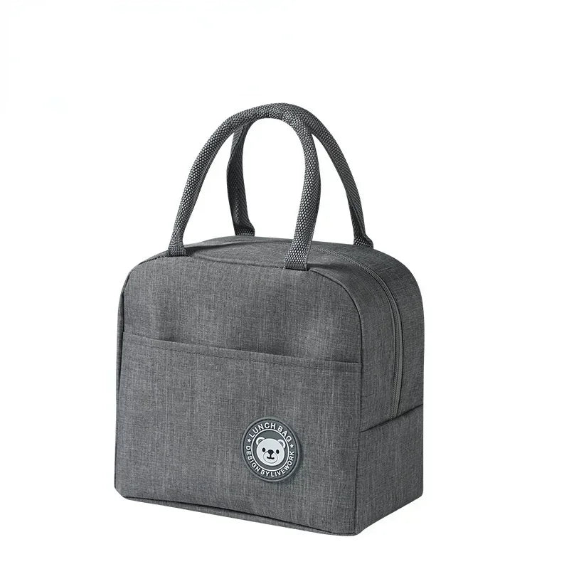 A gray insulated lunch bag with handles is shown against a white background.