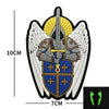 A black and gold embroidered patch featuring an archangel design with wings and a shield.