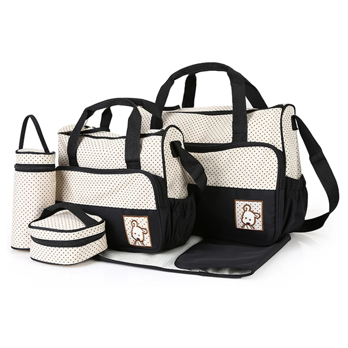 A set of black and white multifunctional crossbody diaper bags for parents.