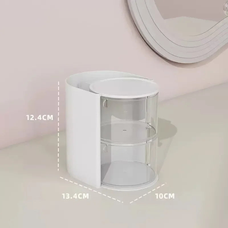 A white clear acrylic hair accessories organizer with rotating compartments displayed on a light surface.