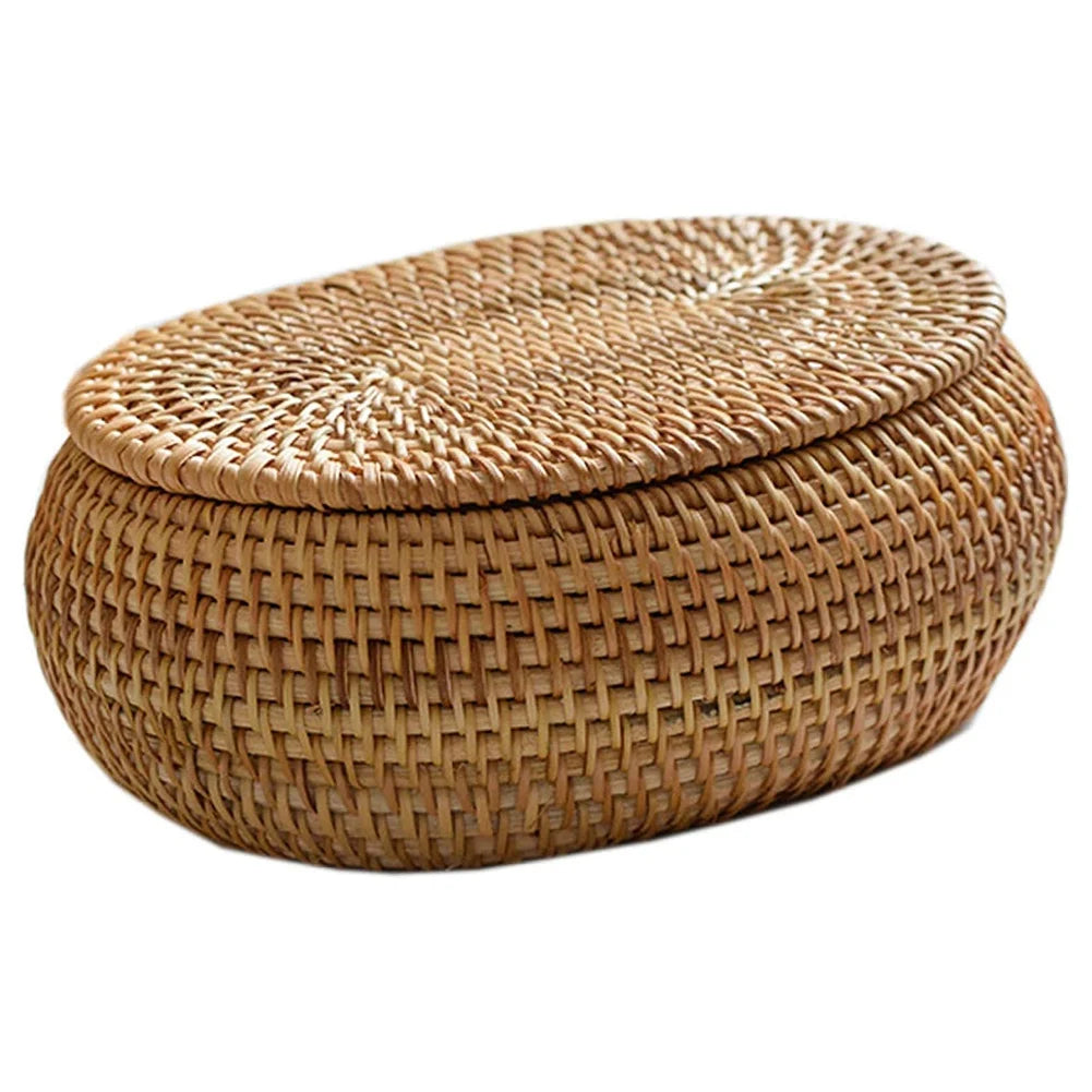 Handwoven rattan storage basket with a lid, made of natural tan fibers.
