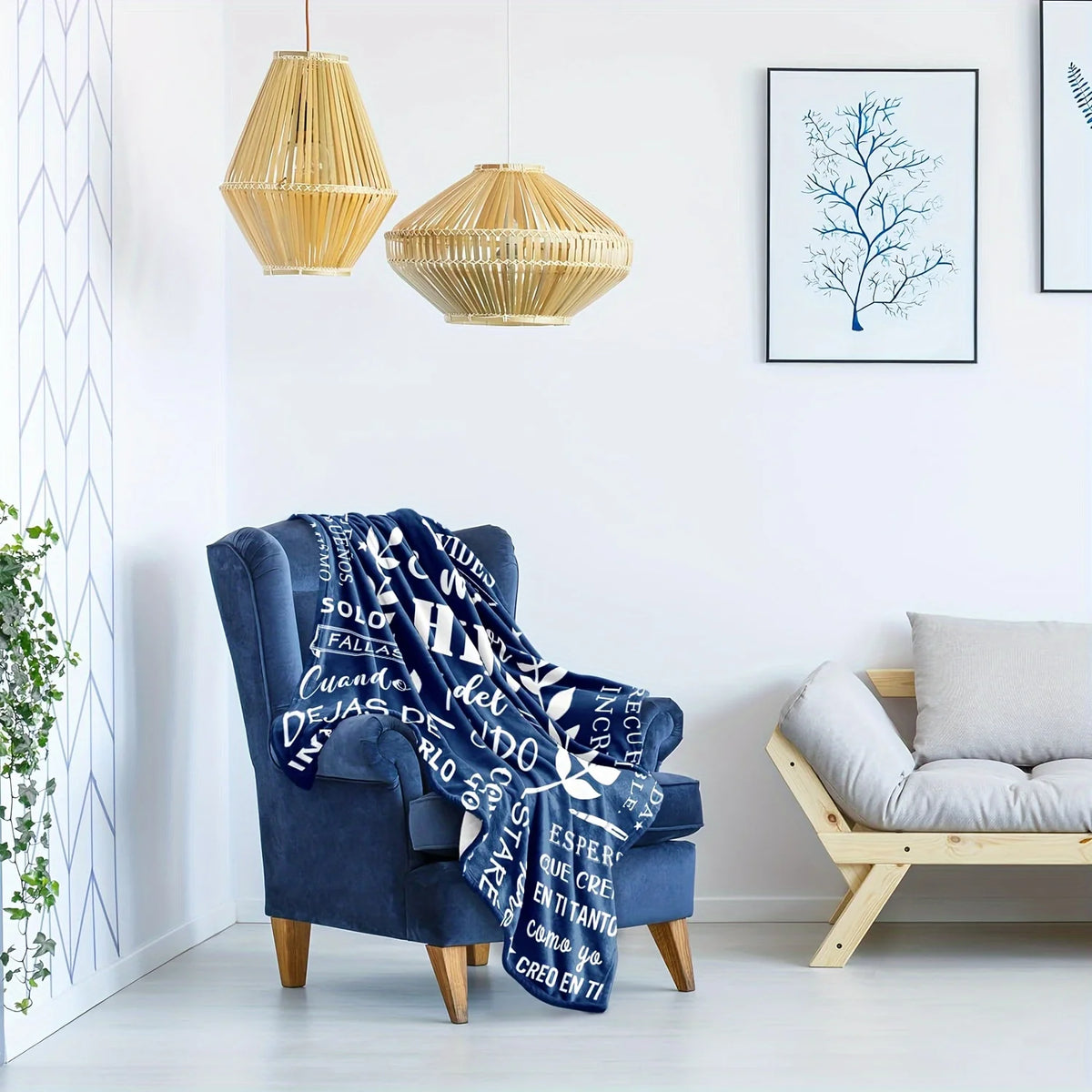 A deep blue fleece throw blanket draped over a velvet armchair in a bright room.