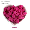 A pile of pink silicone star heart beads in a white bowl for DIY jewelry making