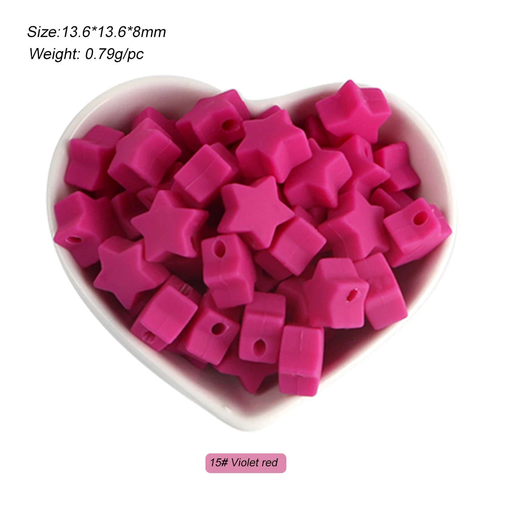 A pile of pink silicone star heart beads in a white bowl for DIY jewelry making