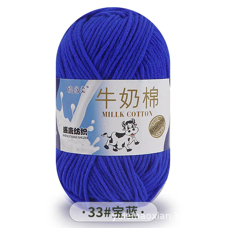 A skein of bright blue Milk Cotton blend yarn with a label in Chinese and English.