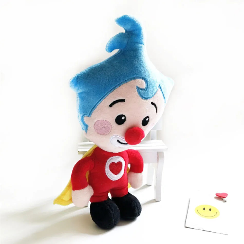 A soft, blue-haired plush toy resembling a clown with a red nose and red outfit.