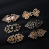 A collection of vintage gold and silver floral clips and brooches for decorating cardigans and shawls