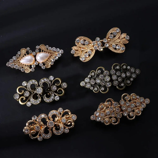 A collection of vintage gold and silver floral clips and brooches for decorating cardigans and shawls