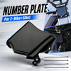 Black number plate for e-bikes, shown with mounting wires.