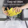 Hands are washing a yellow microfiber towel in a bowl of water to clean stains.