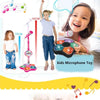 A young girl stands next to a microphone stand and holds a colorful kids microphone toy for karaoke.