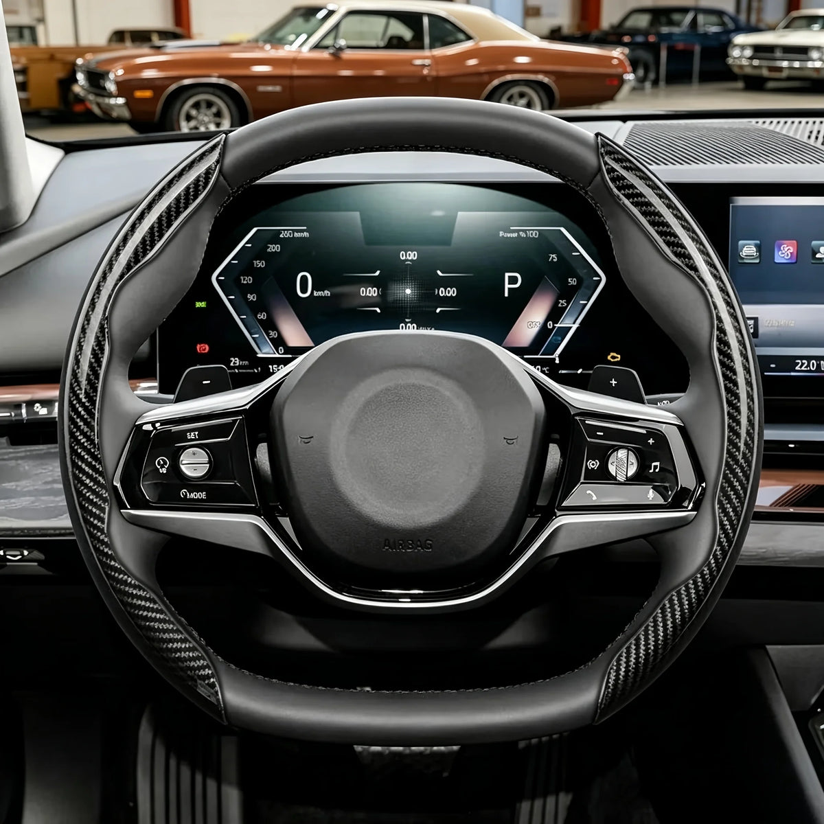 Close-up view of a black steering wheel with carbon fiber pattern grips and controls inside a vehicle