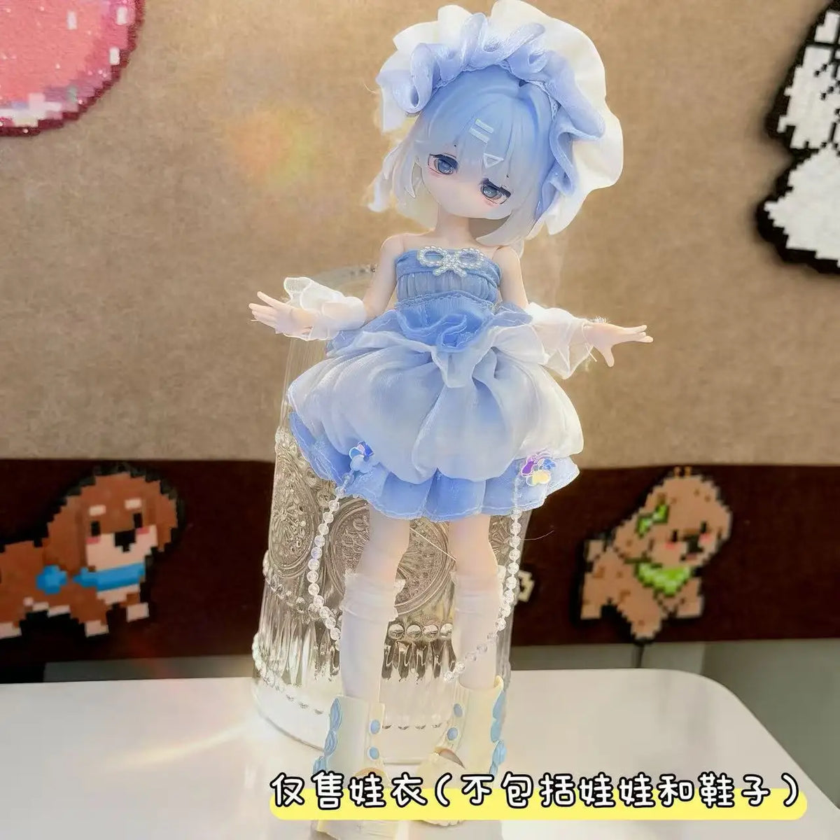 A light blue hair doll wearing a ruffled dress outfit with sheer fabric and white boots.