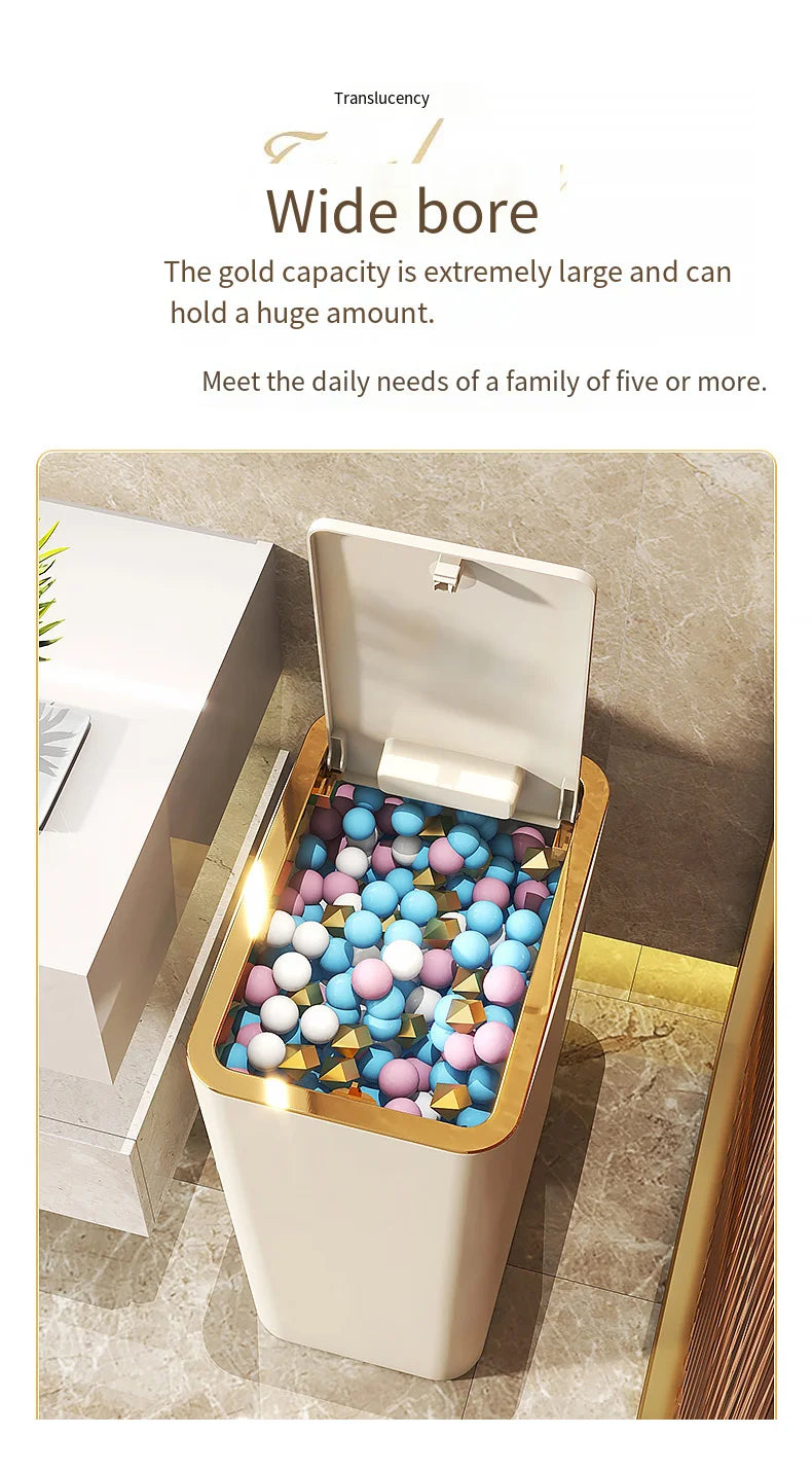 A gold-colored pop-up slim trash can is shown open, filled with colorful spherical items, on a marble surface.