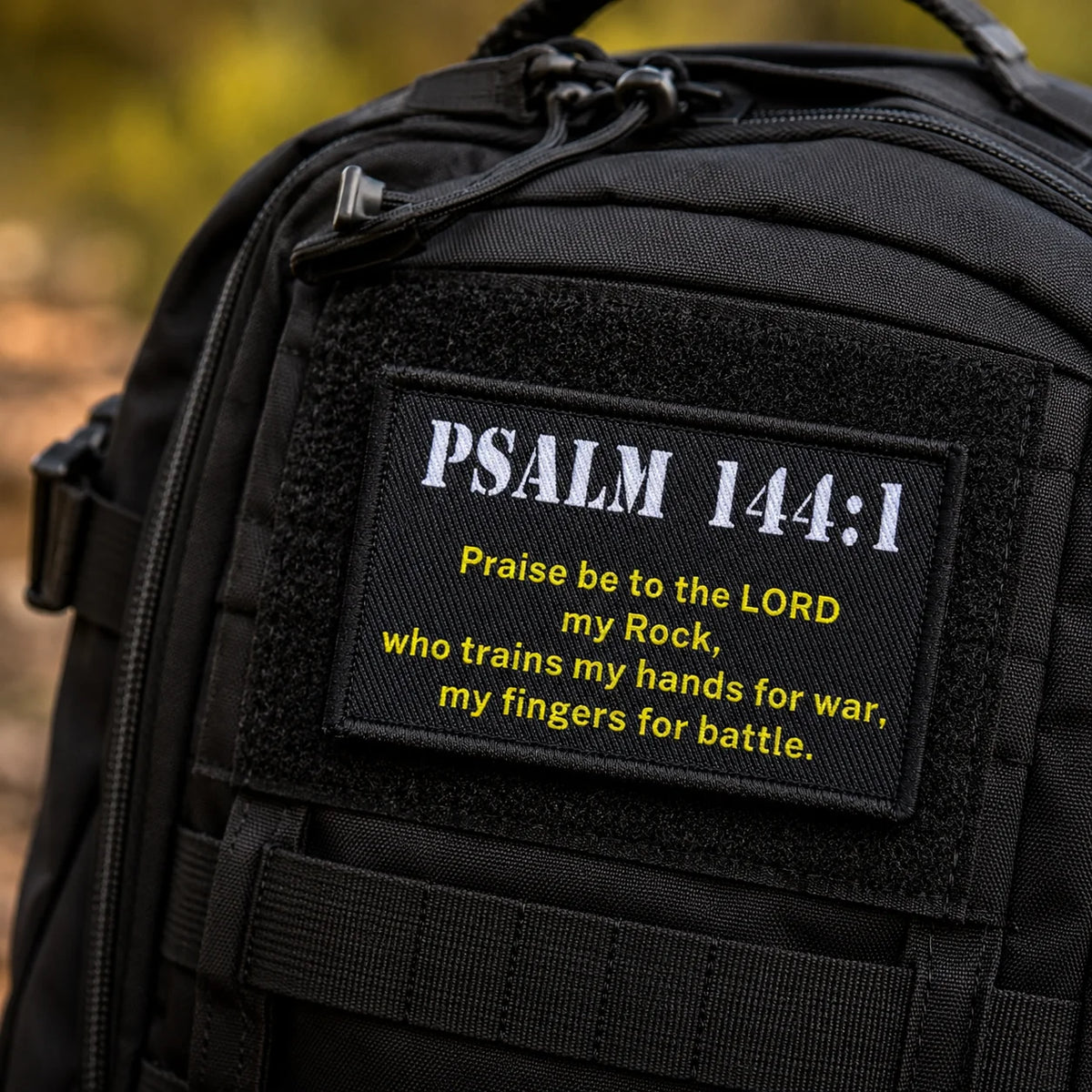 Black tactical backpack featuring an embroidered Psalm 144:1 morale patch.