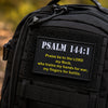 Black tactical backpack featuring an embroidered Psalm 144:1 morale patch.