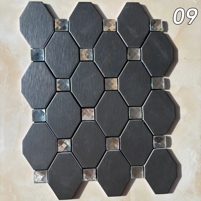 A pattern of dark gray hexagonal mosaic tiles installed on a light beige wall surface.