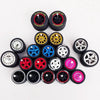 A collection of 10 pairs of 1:64 scale alloy car wheels and tires in various colors including black, gold, blue, red, and sil