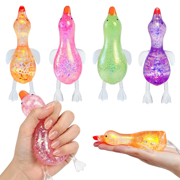 A hand holds a pink squishy stress ball and several colorful duck-shaped squishies.