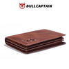 A brown genuine leather men's bi-fold wallet with a logo, shown flat.