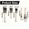 A set of five paint brushes with varying sizes and handles shown next to a ruler for scale.