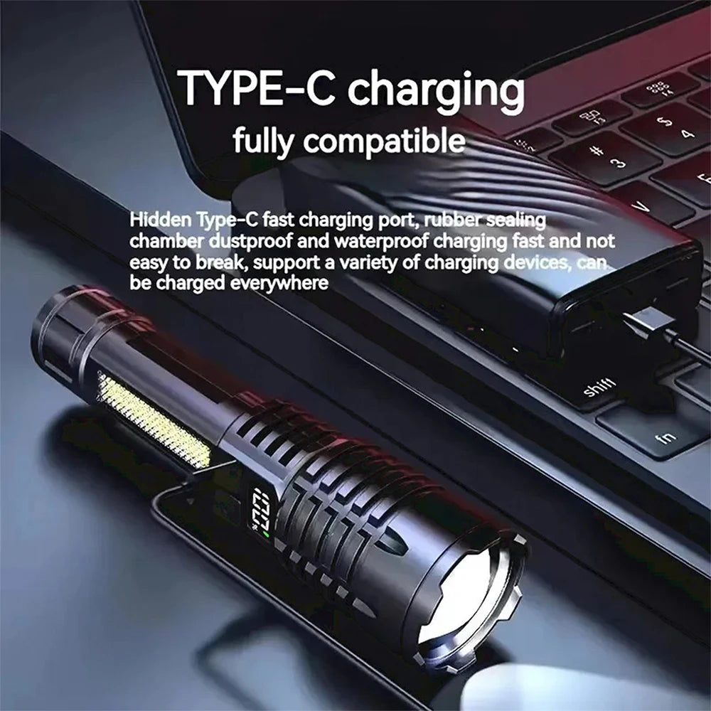 A black high-power LED rechargeable flashlight with a side light is shown next to a laptop.