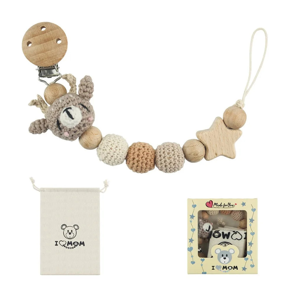 A wooden pacifier clip with a chain of crochet beads and a small pouch featuring a baby bear design.