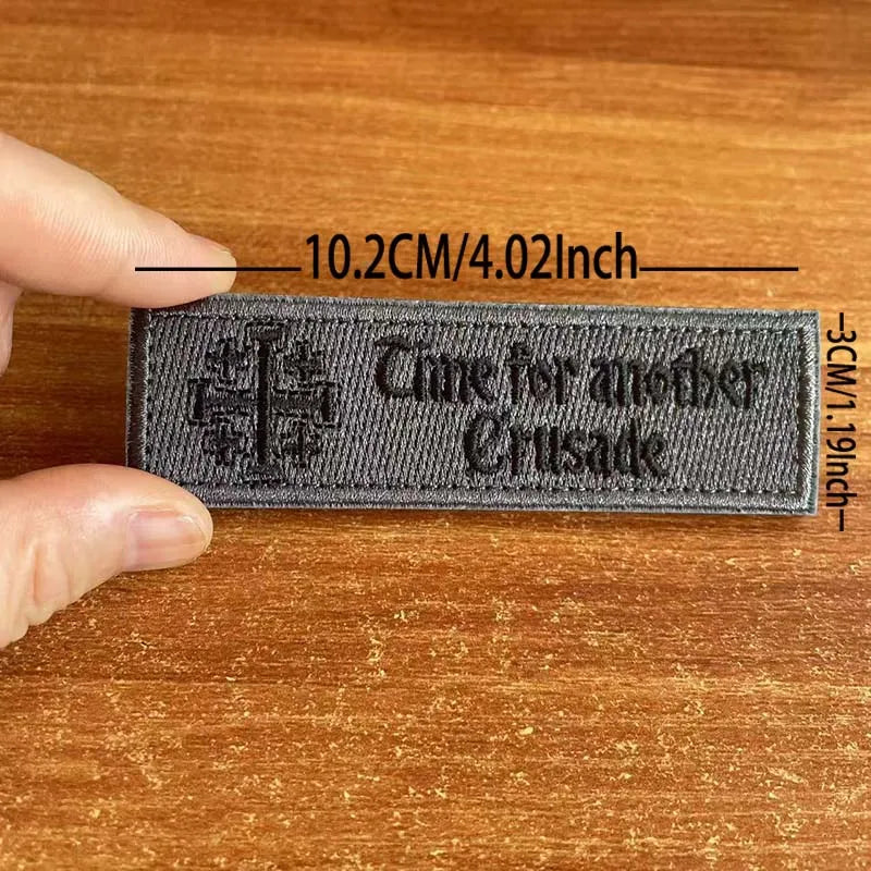 A dark gray embroidered tactical patch featuring the text Time for another Crusade.