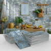 Stacks of marble self-adhesive wall stickers in various shades of blue and gray against a rustic kitchen background.