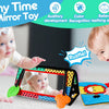 A baby is interacting with a high-contrast crinkle cloth book and tummy time mirror toy.