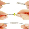 Stainless steel wire keychain cable with screw lock being held by fingers