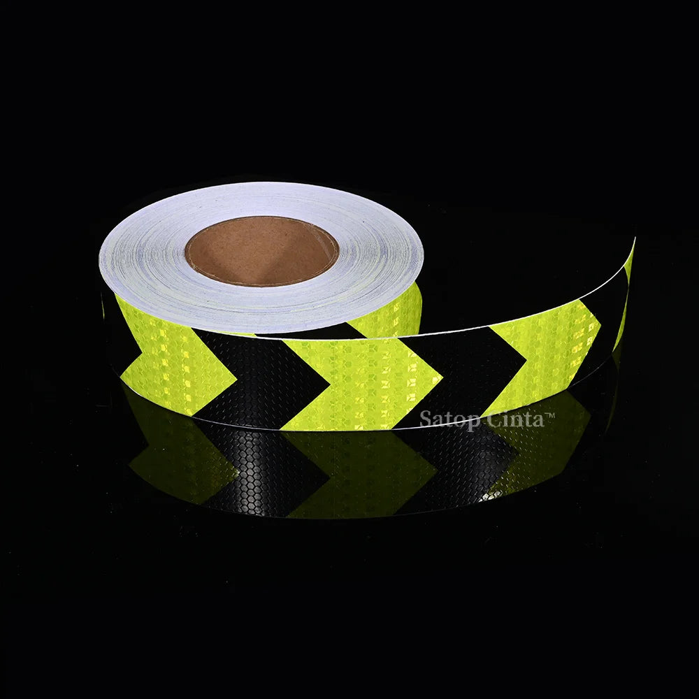 Roll of yellow high-visibility reflective safety tape for vehicles on a black background