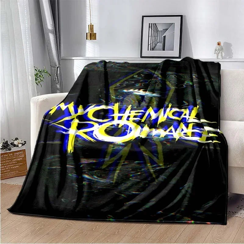 A black fleece throw blanket featuring the My Chemical Romance band logo in yellow and blue text.