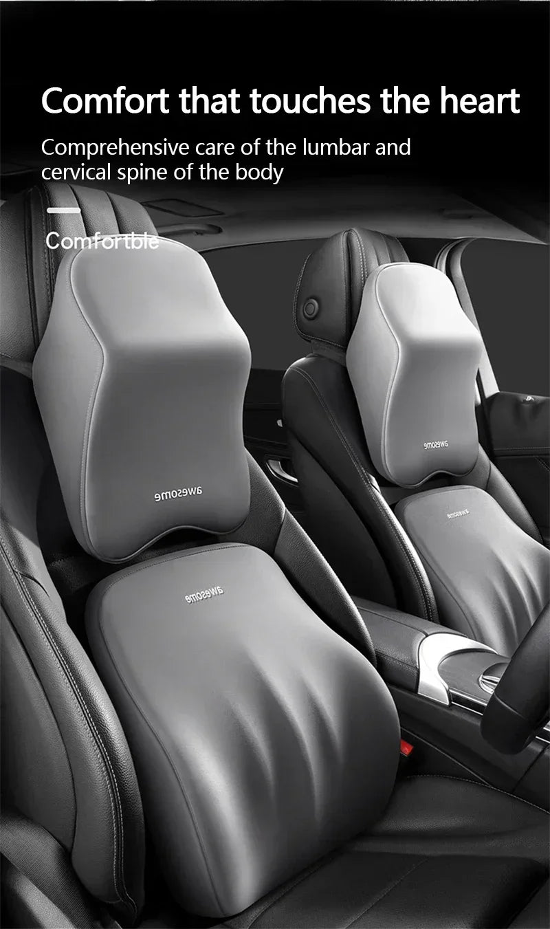 A close-up view of a black memory foam car headrest pillow with shoulder support on a vehicle seat.