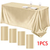 A luxurious satin gold tablecloth set with silverware and wine glasses displayed on a table.