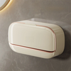 A rectangular, cream-colored wall mounted soap dish with a copper rim is displayed against a gray marble background.