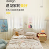 A simple style bedroom featuring a bed with a lace-trim breathable summer duvet and light decor.