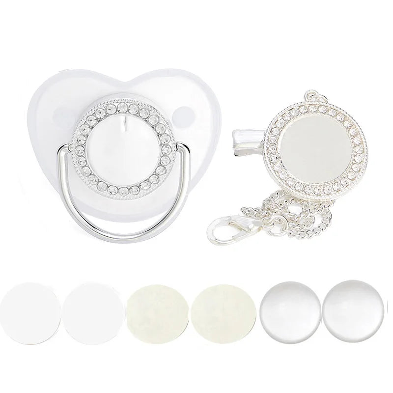 A sparkling rhinestone pacifier with a clip designed for babies, shown alongside several white silicone pacifiers.