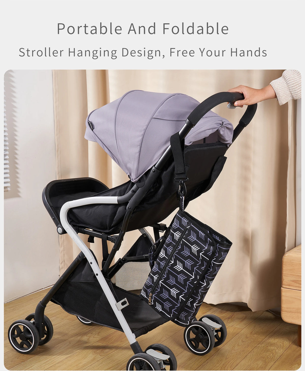 A portable and foldable stroller hanging design featuring a gray baby changing pad and storage bag.