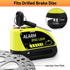 Yellow motorcycle disc brake lock with an alarm feature and a silicone grip shown next to a brake disc.