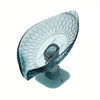 A clear glass soap dish with a leaf design and suction cup base.