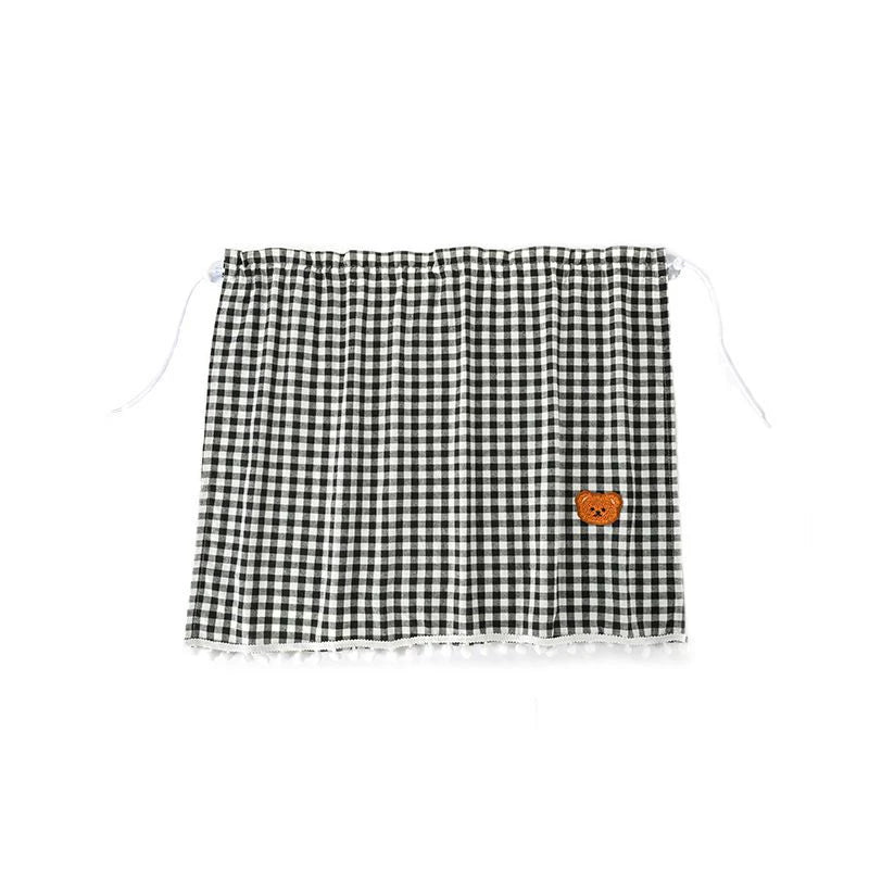 Black and white checkered sun shade curtains featuring a cartoon bear patch.