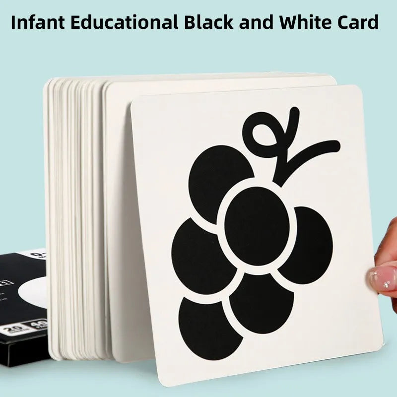 A stack of black and white infant educational flash cards featuring a large black grape design.