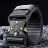 A close-up of a black tactical nylon belt with a secure metal buckle resting on a dark, textured surface.