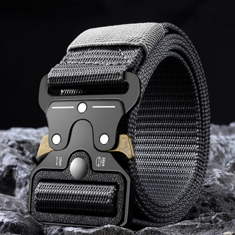 A close-up of a black tactical nylon belt with a secure metal buckle resting on a dark, textured surface.