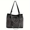 A black crystal-embellished chain shoulder bag with a long strap.