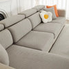 A light gray jacquard elastic sofa slipcover with orange accent pillows on a white background.